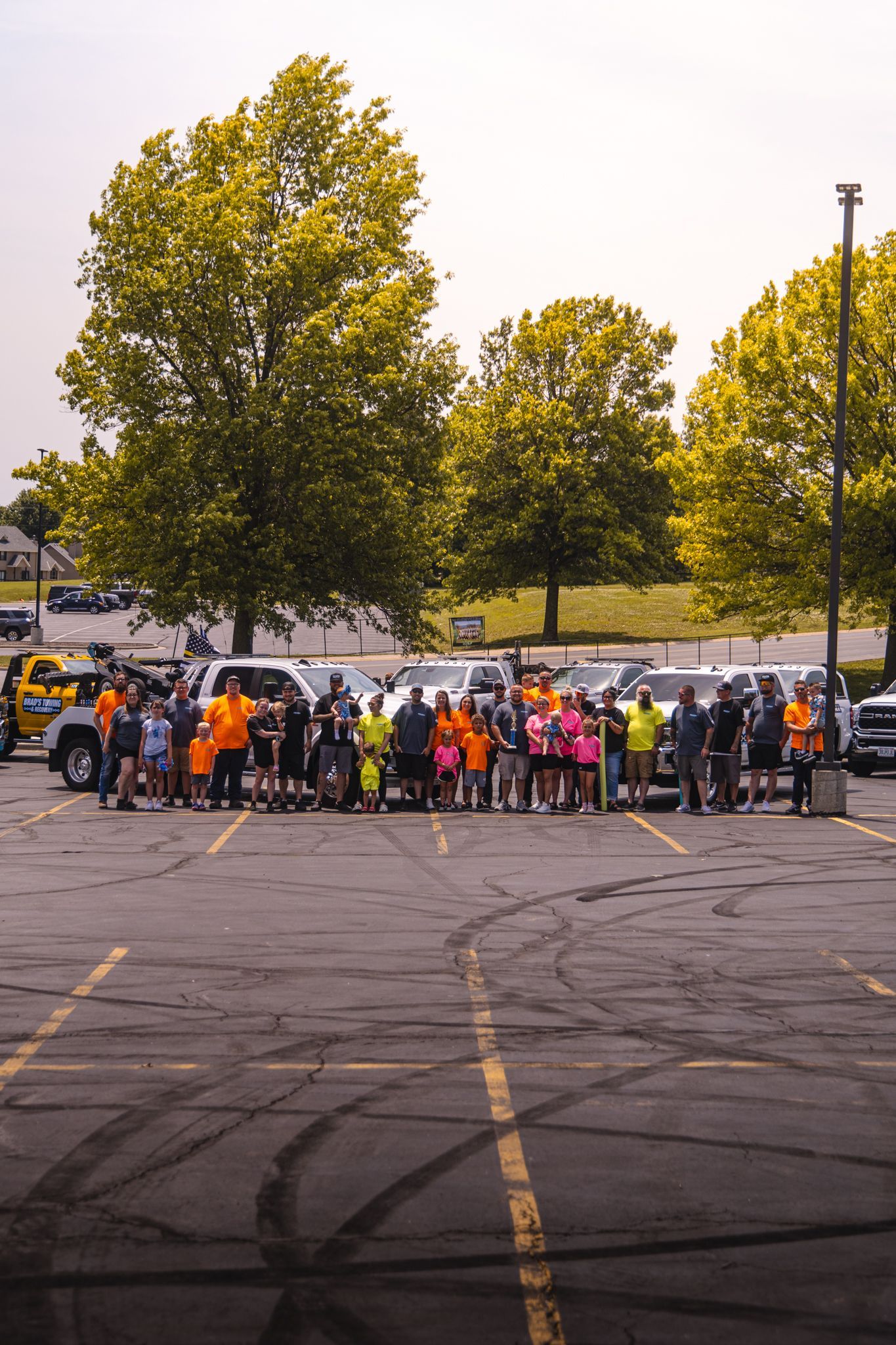 A group of people are standing in a parking lot.