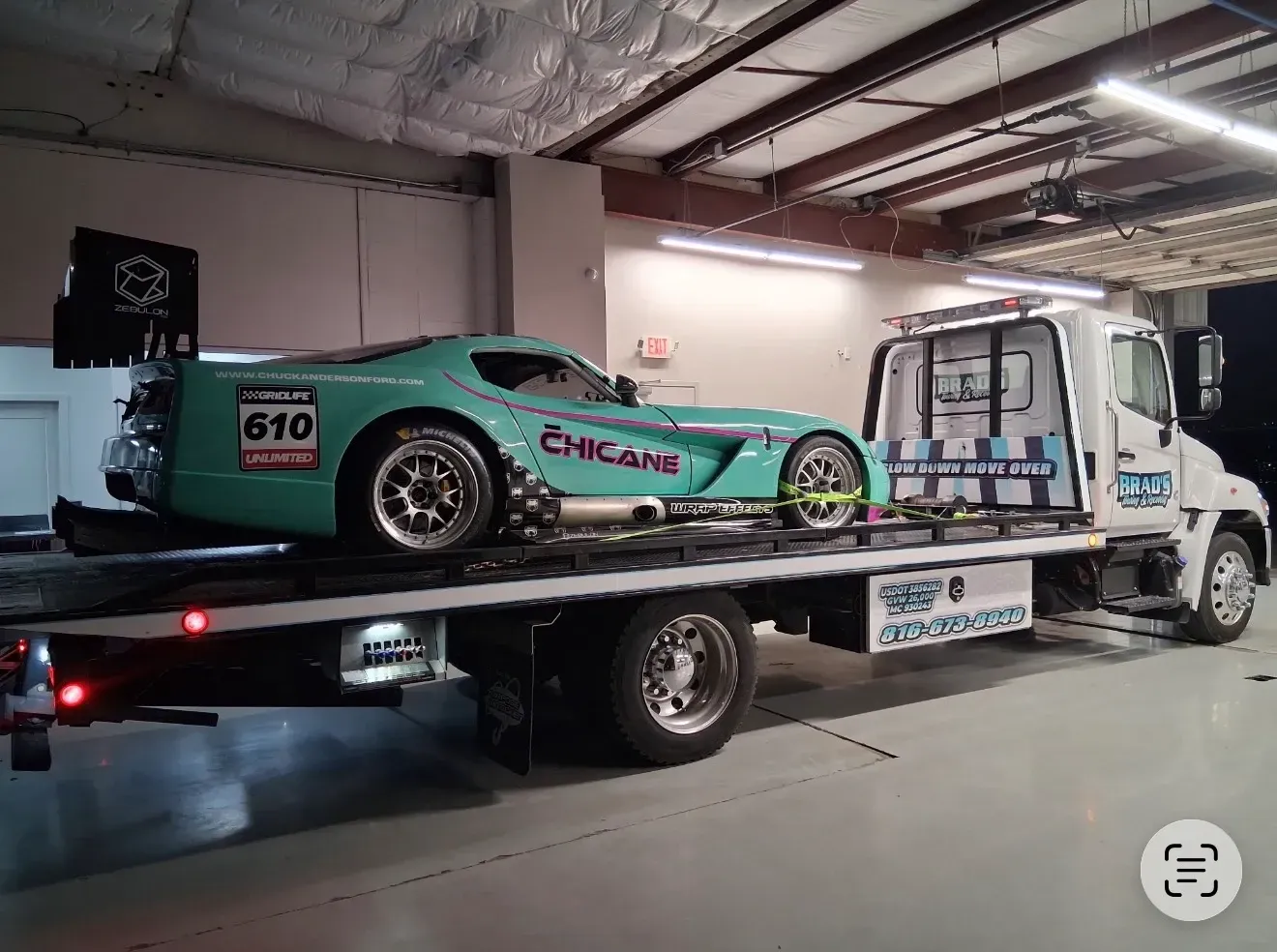 The back of a tow truck with the words brad 's towing on it.