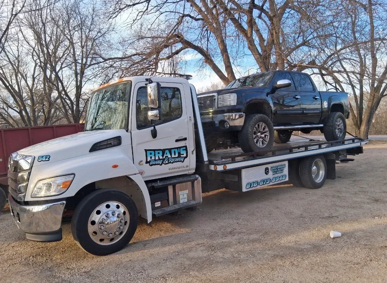 The back of a tow truck with the words brad 's towing on it.