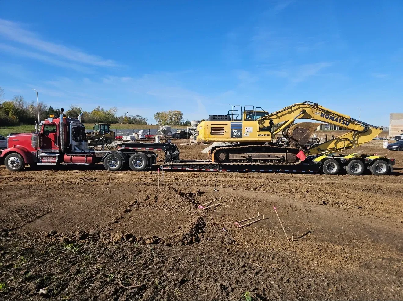 A man is standing in front of a tow truck that says tow truck