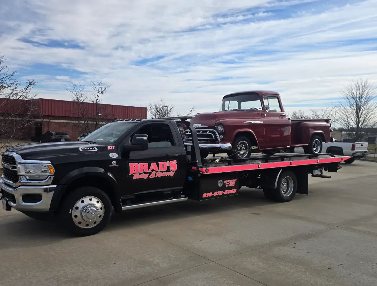 The back of a tow truck with the words brad 's towing on it.