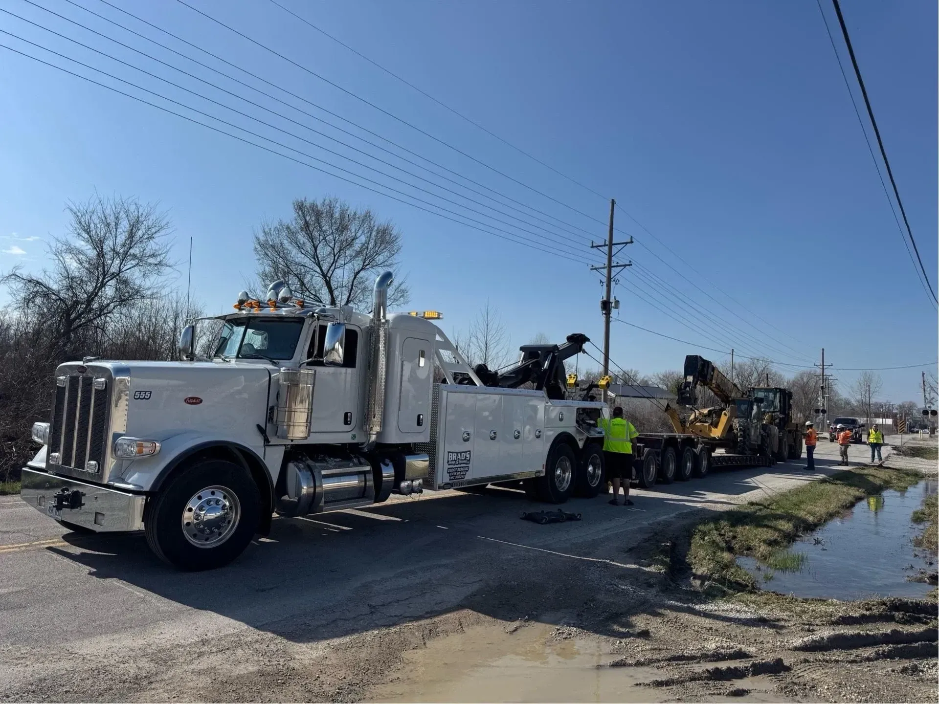 The back of a tow truck with the words brad 's towing on it.