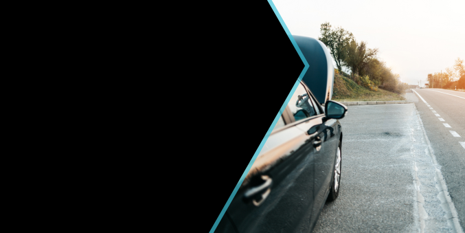 A black car is parked on the side of the road.