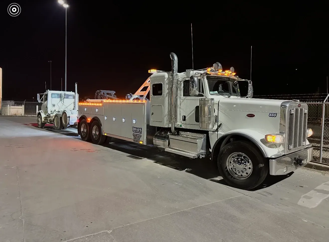 The back of a tow truck with the words brad 's towing on it.