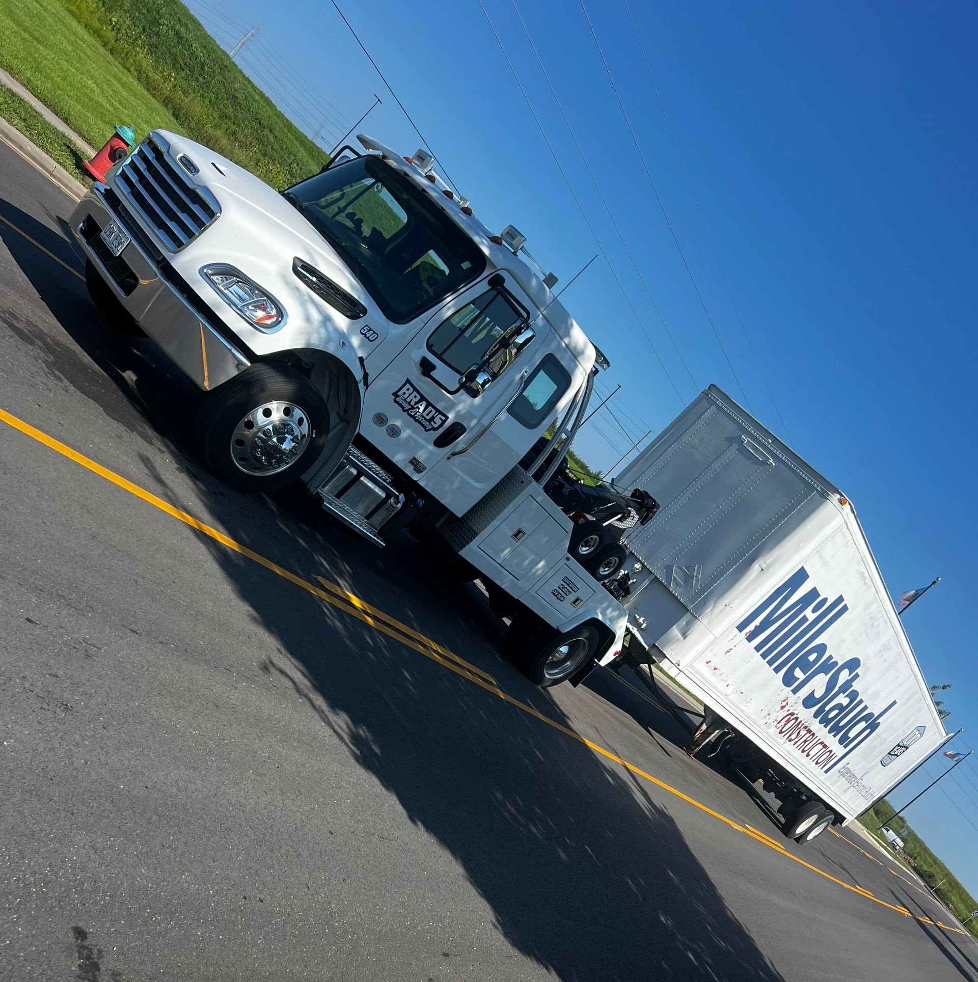 White Miller Starch truck on road, blue sky.