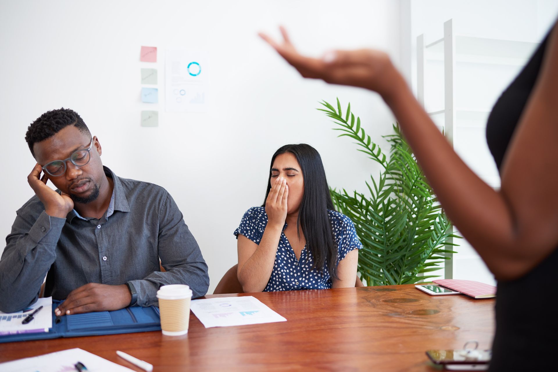 Woman calculating insurance costs with car and house models, digital overlay.