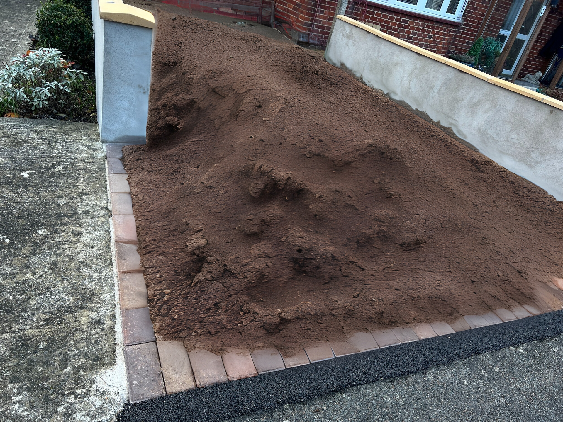 Before resin bound driveway installation, green grass in the front garden.