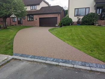 Dark gold resin driveway installation.