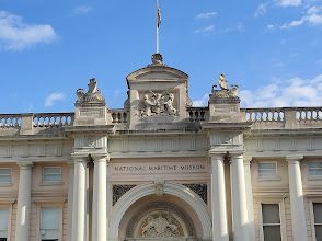 A large building with columns and a flag on top of it.