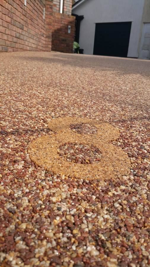 Number eight on a red driveway.