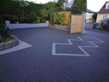 Dark resin patio installation with a diamond pattern in a light grey colour.