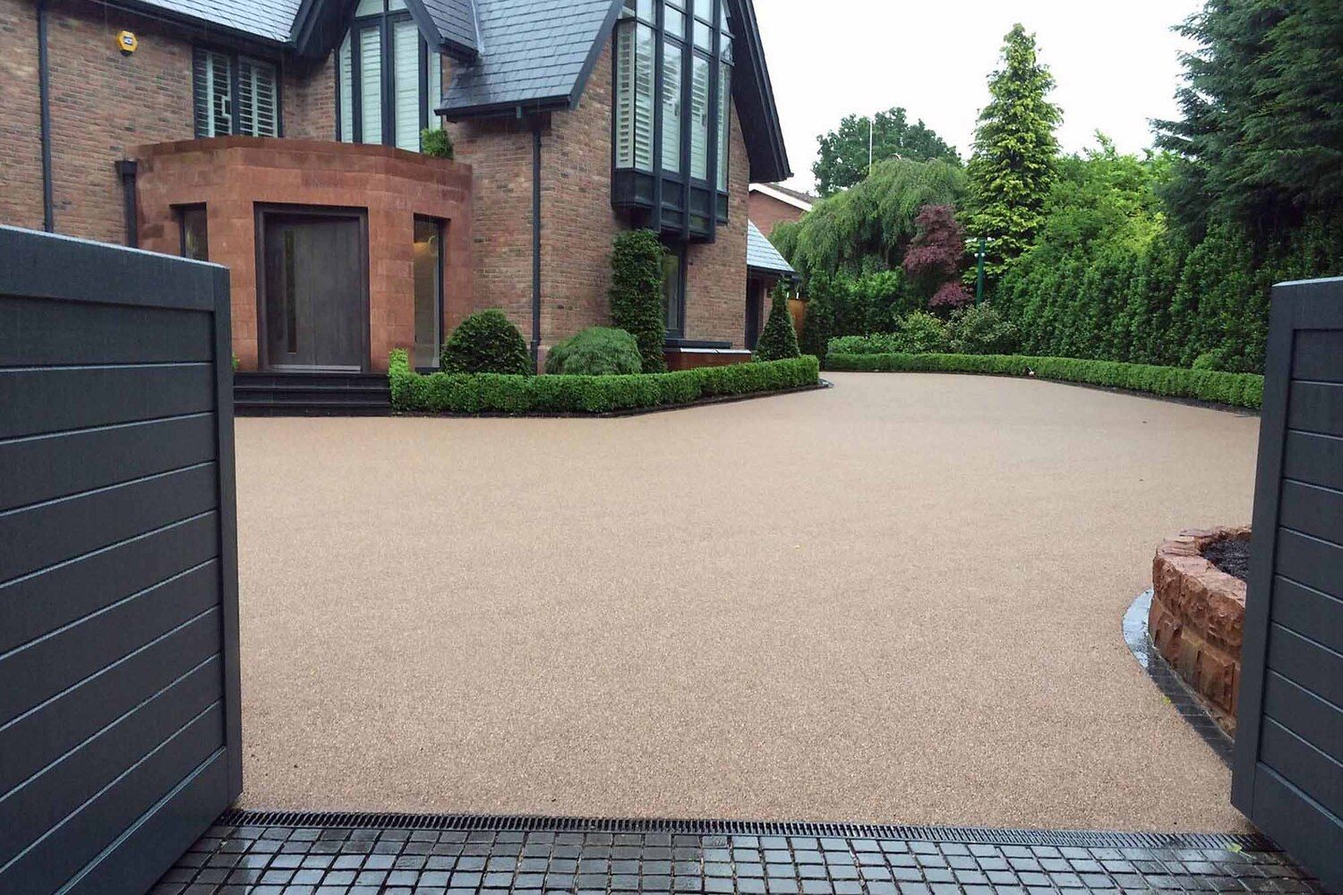 Golden resin driveway for a large new-build property.