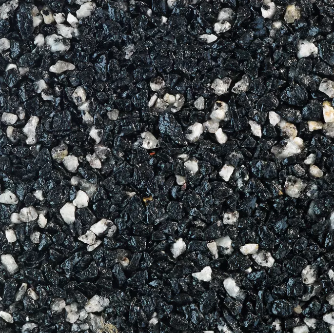 Black and white aggregate surface. Small, dark stones with interspersed light-colored chips.