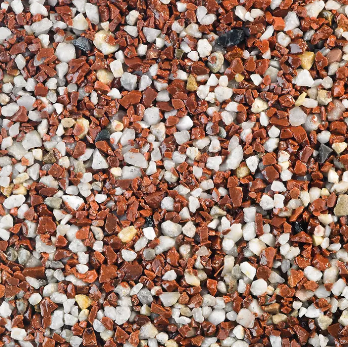 Close-up of a speckled surface with red-brown, white, and gray aggregate.