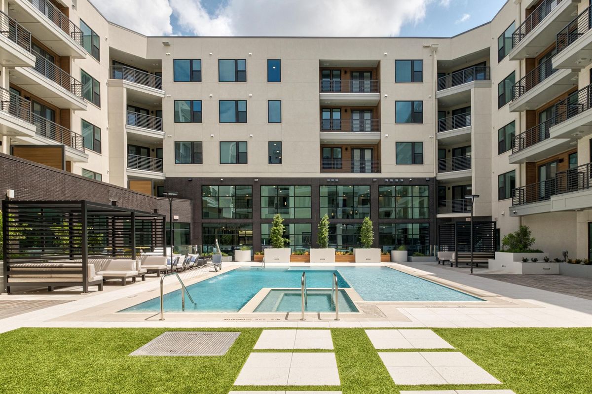 persons walking into the pool courtyard