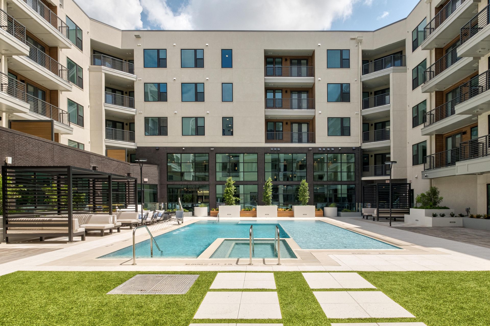 persons walking into the pool courtyard