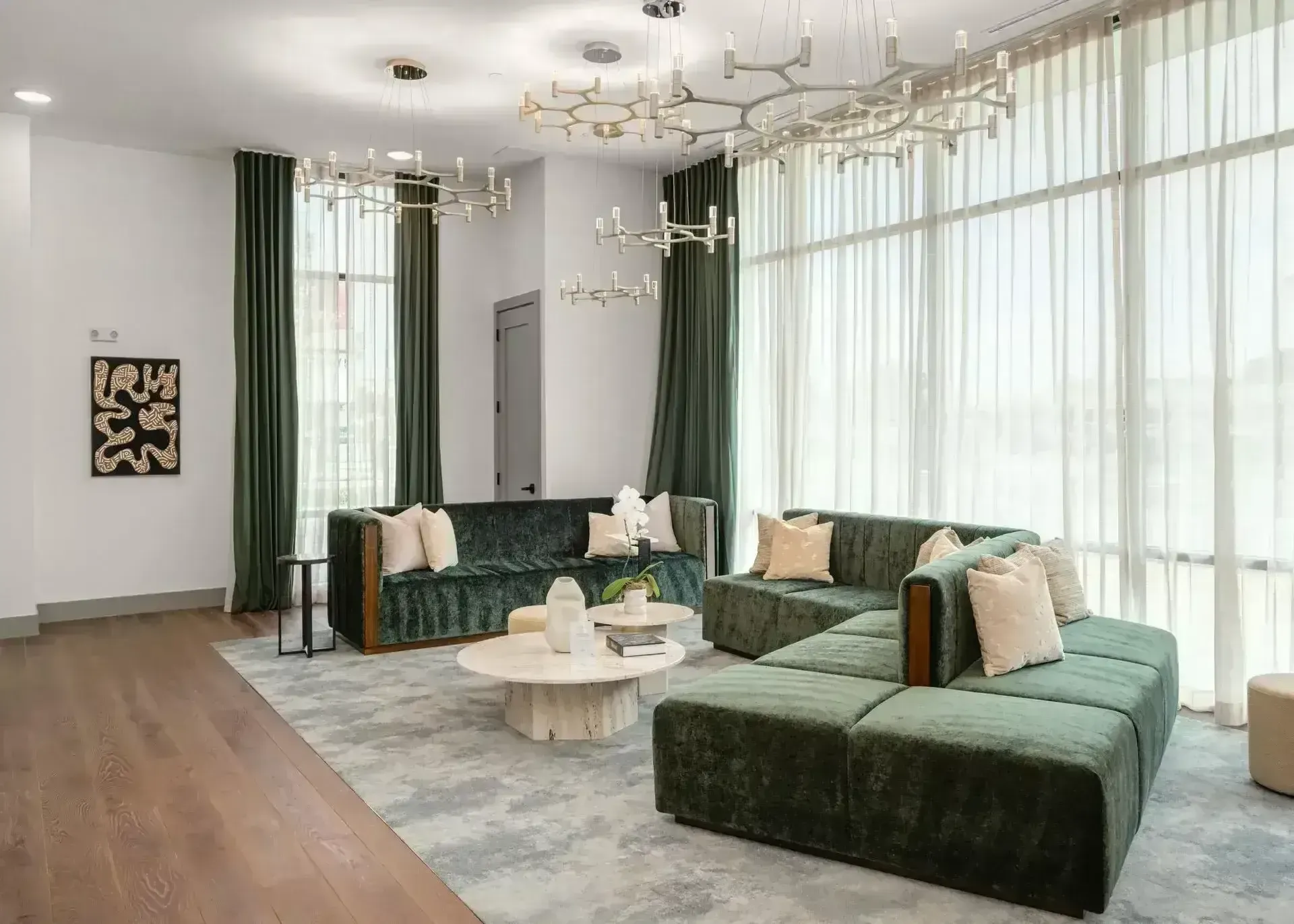 A living room with a green couch and a white coffee table at The Anderson 