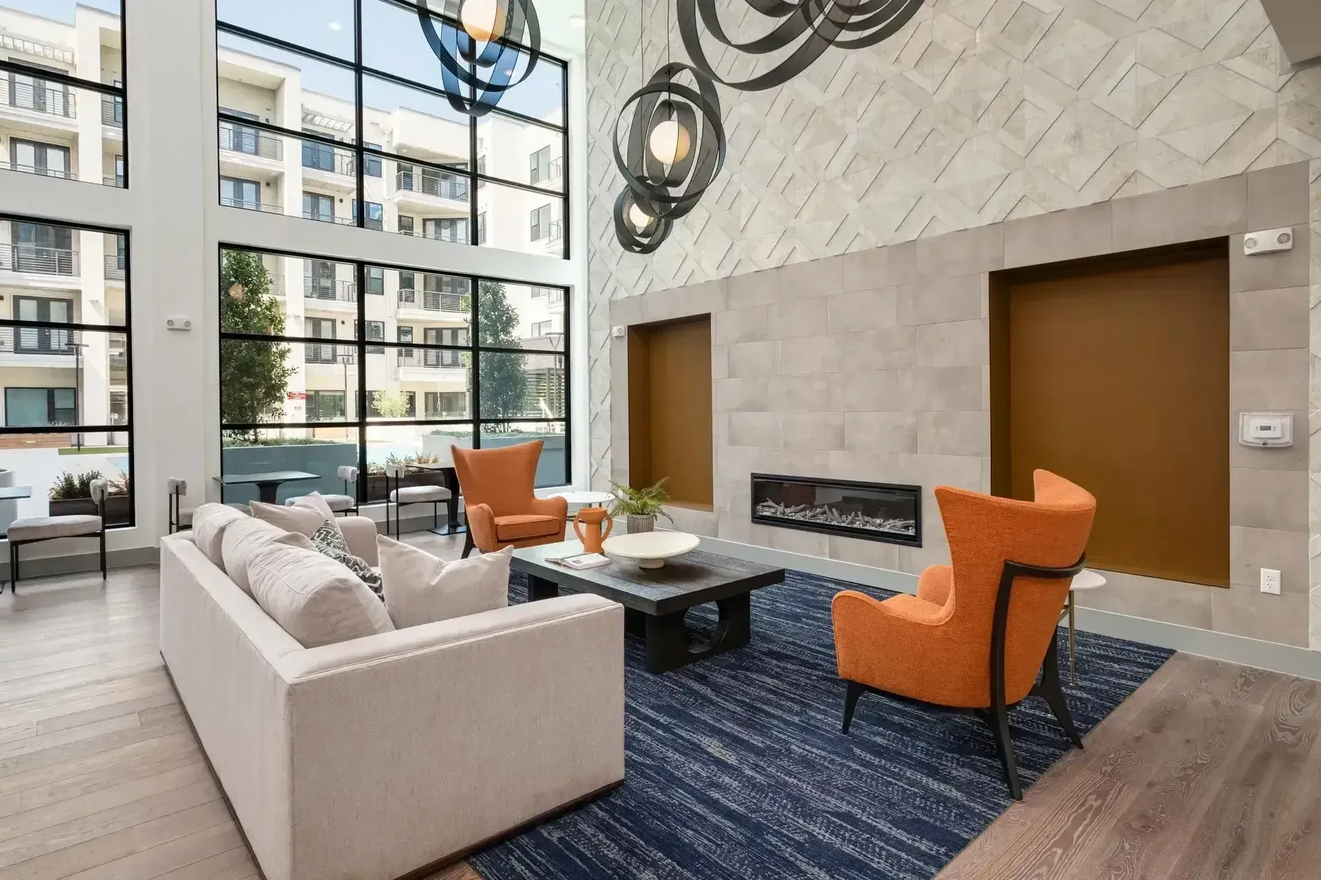 A living room with a couch , chairs , coffee table and fireplace at The Anderson 