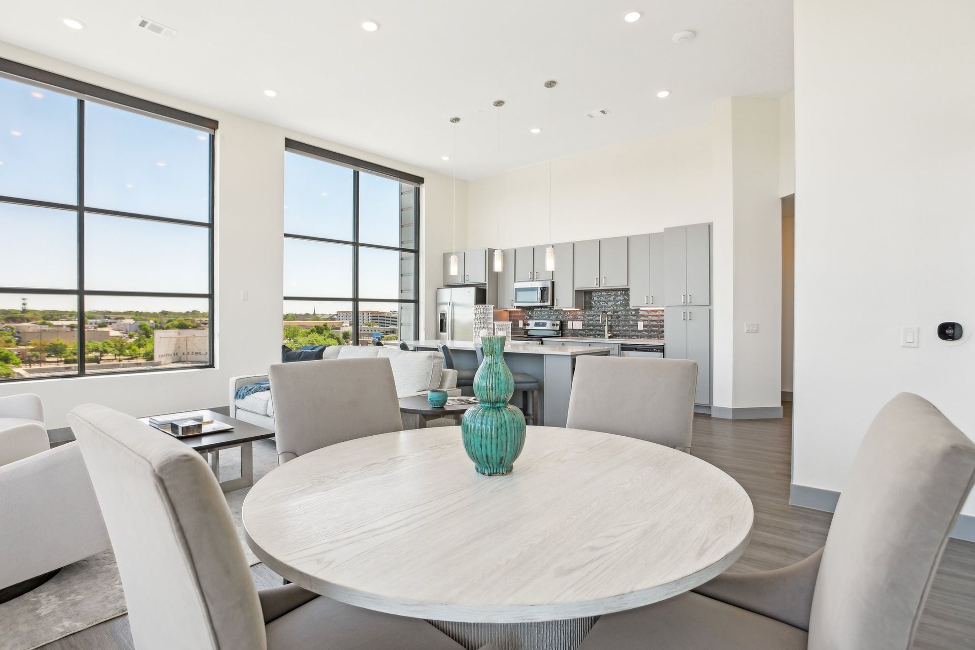 A dining table with view of kitchen area