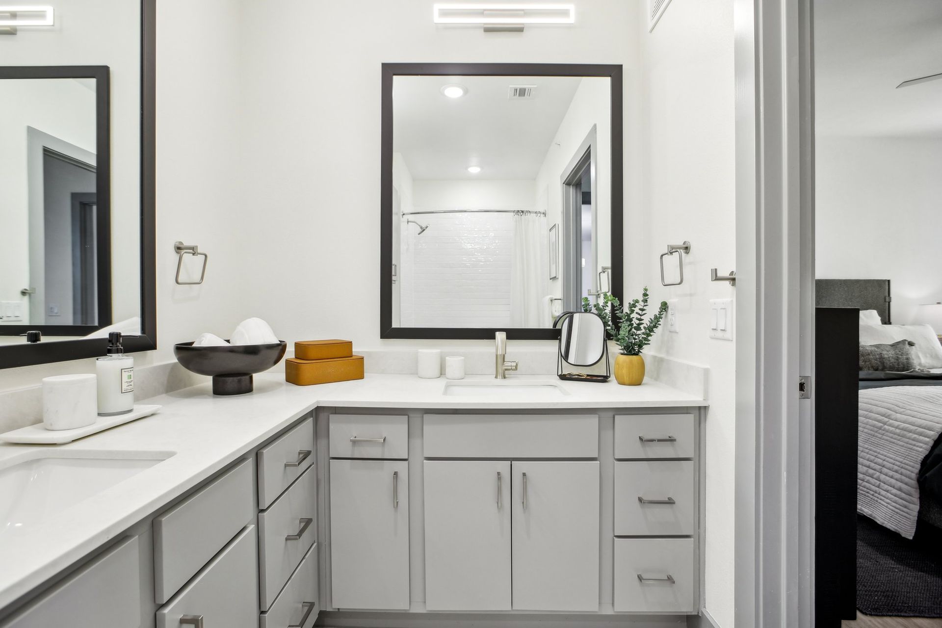 L shaped bathroom with dual vanities