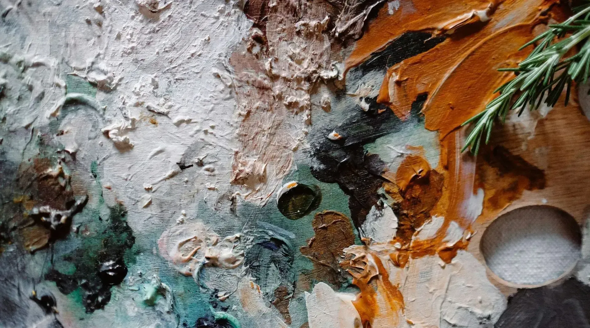 A close up of a painting with a plant in the background