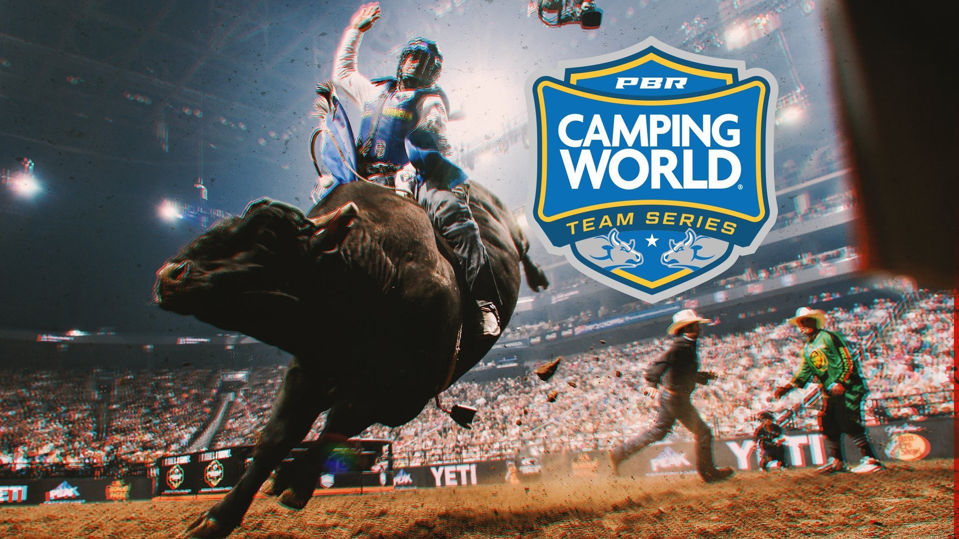 A man is riding a bull in a rodeo arena.