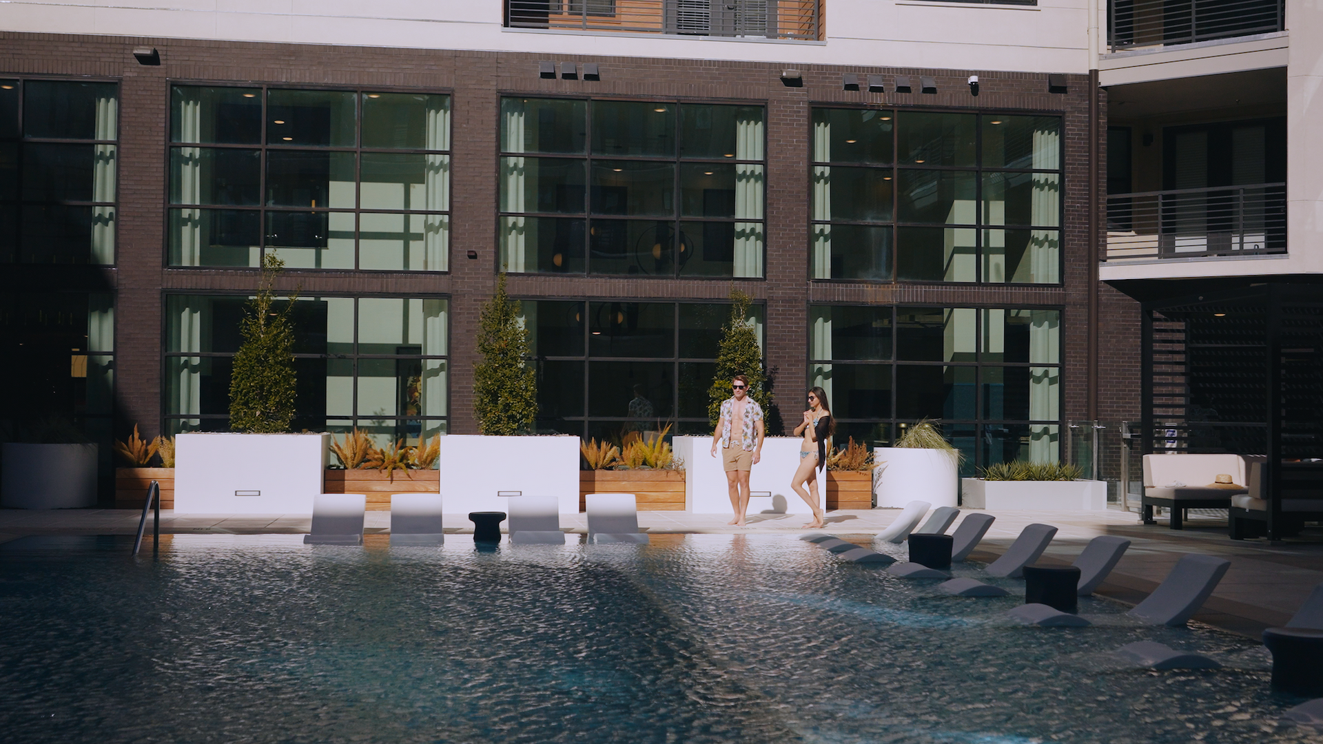 Pool area with two people in the pool