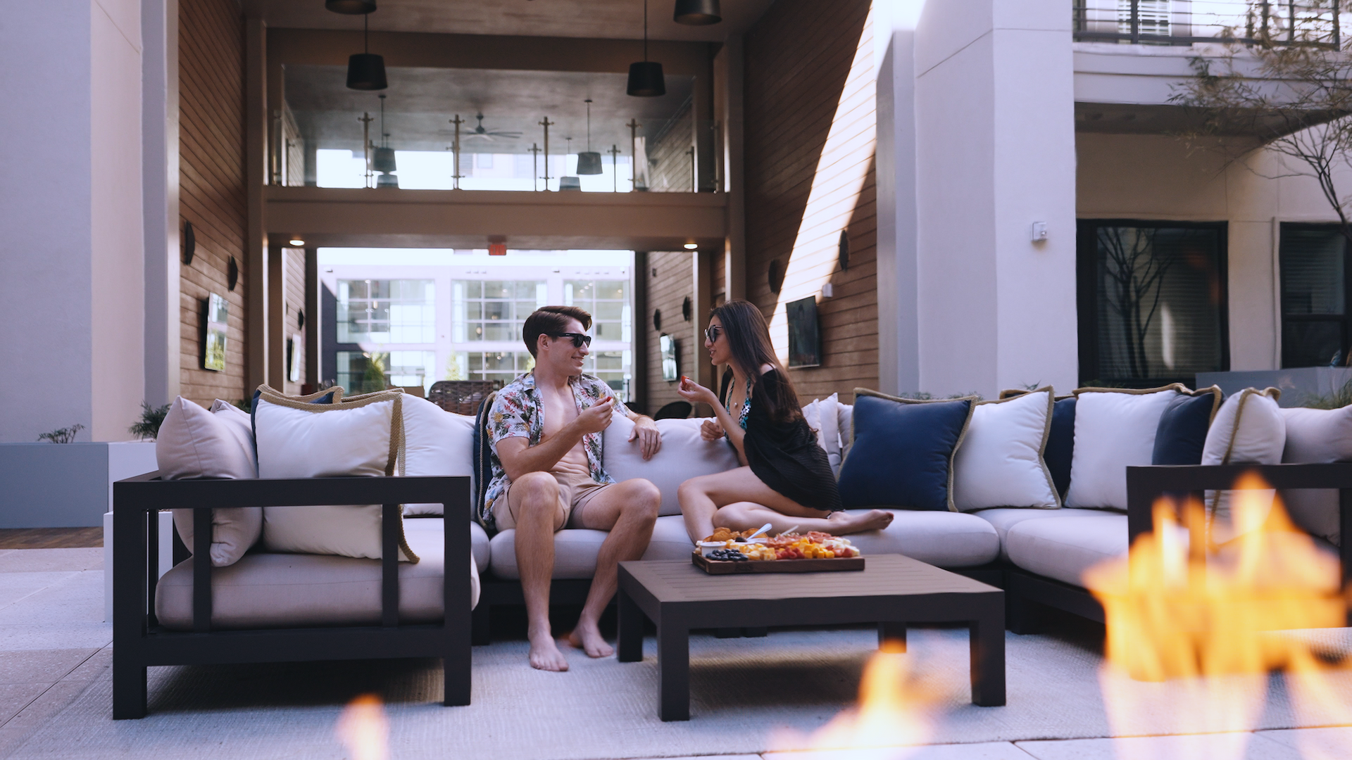 people sitting outside by firepit