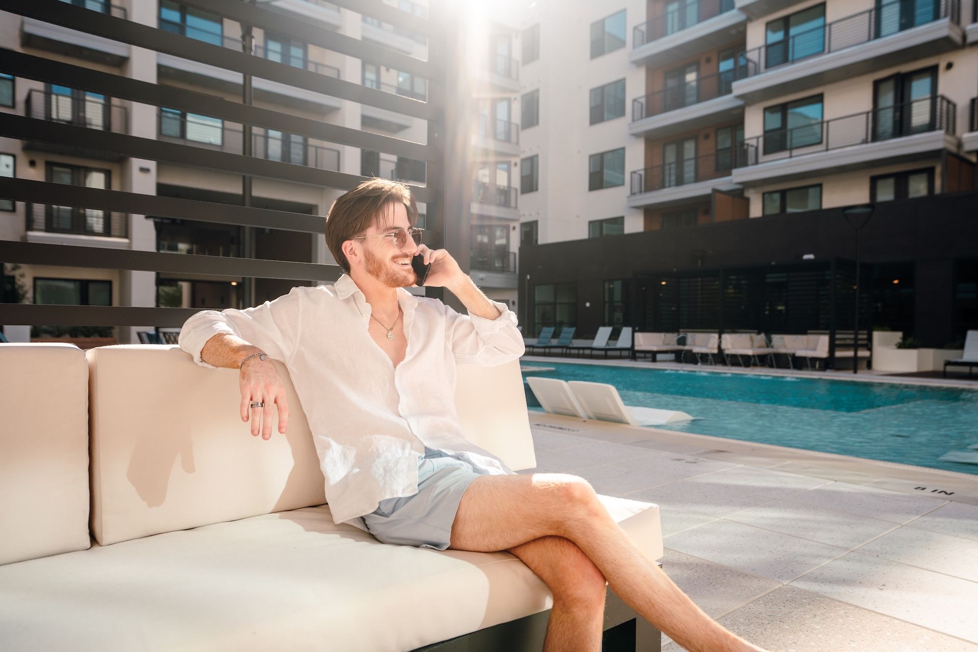 A man by the pool on the phone