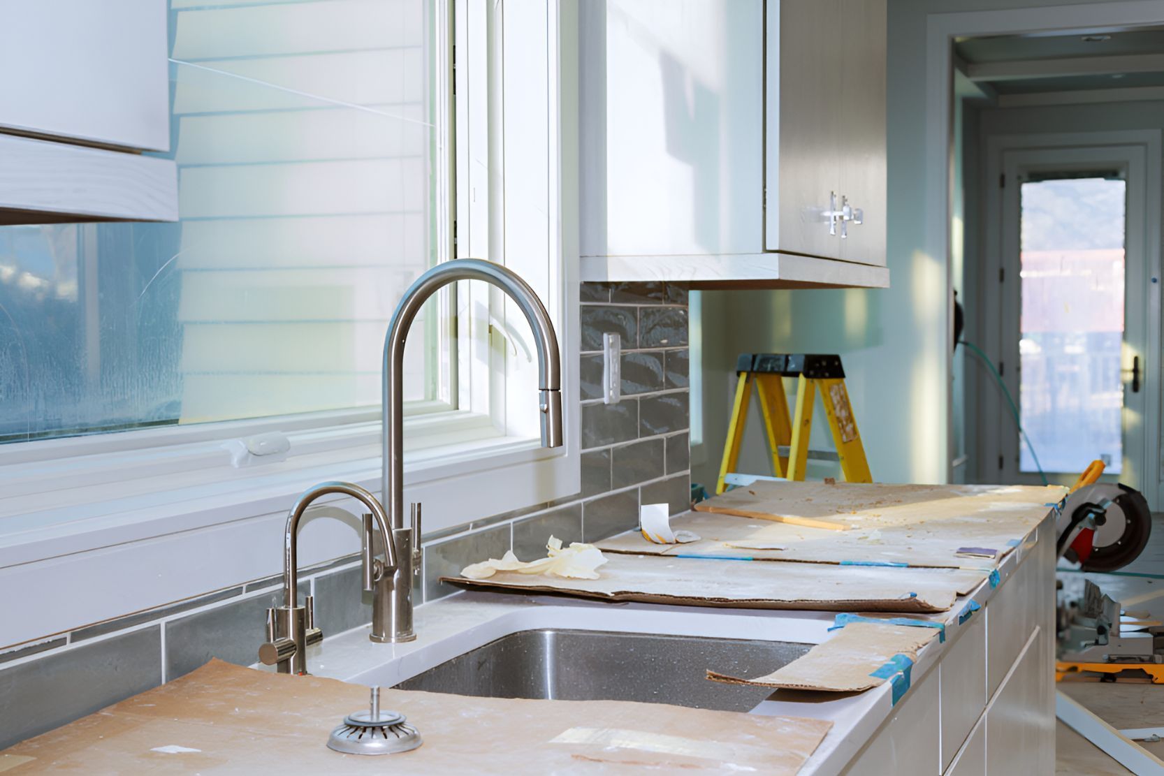 A Kitchen Under Construction With a Sink and a Window — Foreshore Kitchens In Gympie, QLD