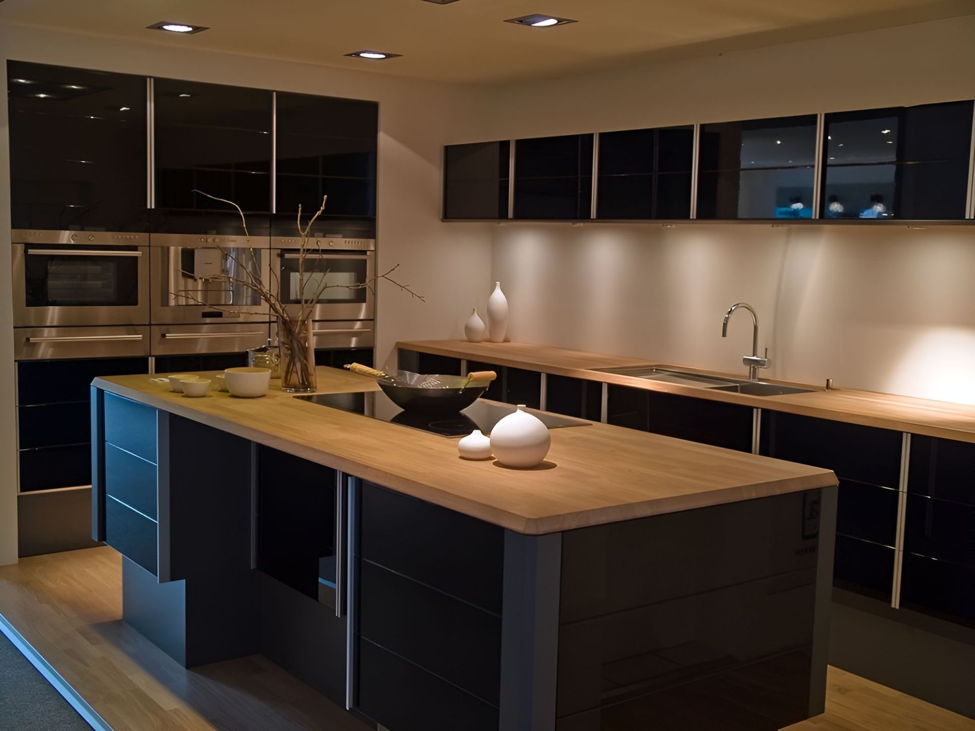 A Kitchen With Black Cabinets and a Large Wooden Island — Foreshore Kitchens In Mooloolaba, QLD