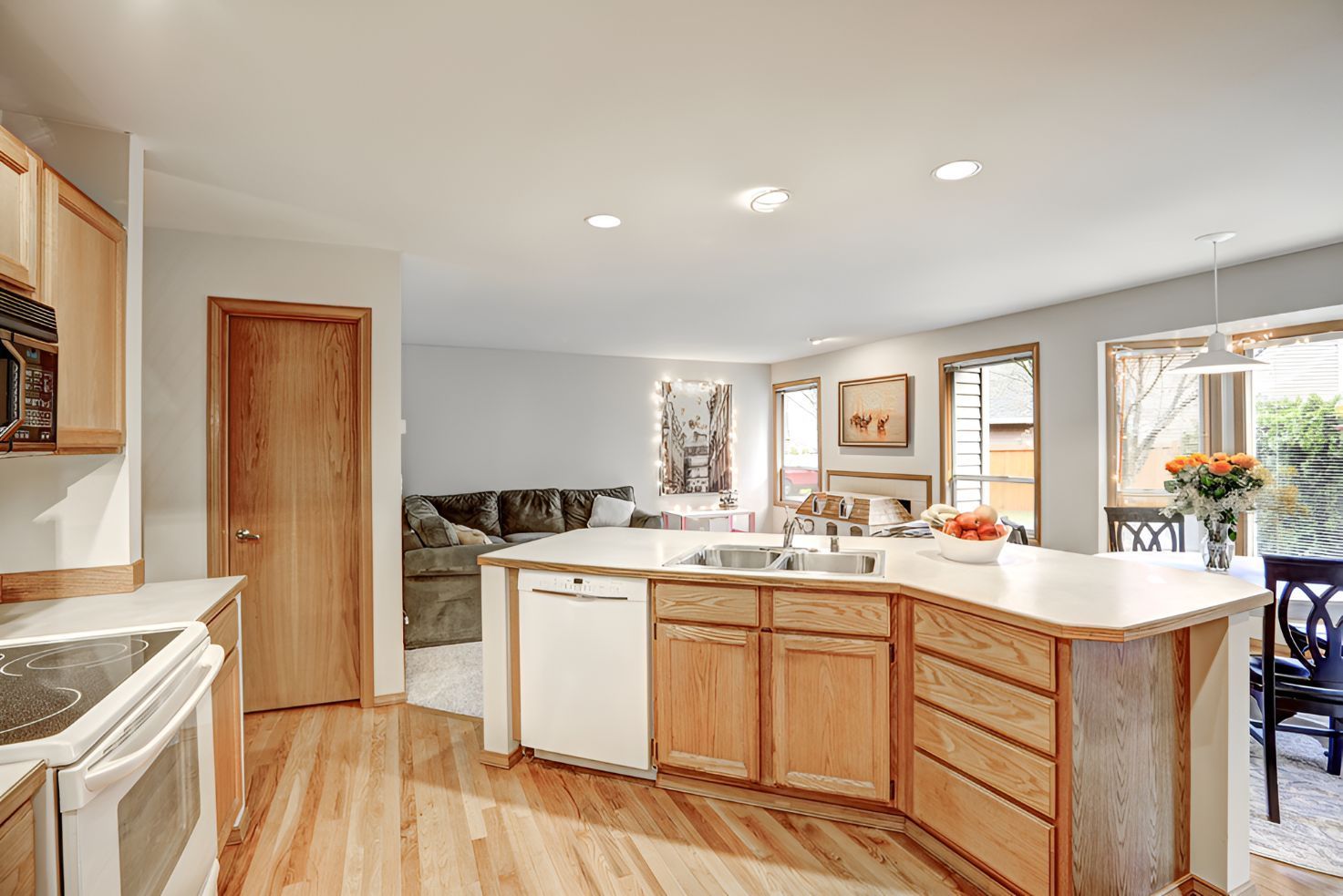 A Kitchen With Wooden Cabinets , White Counter Tops, a Sink, and a Stove — Foreshore Kitchens In Twin Waters, QLD