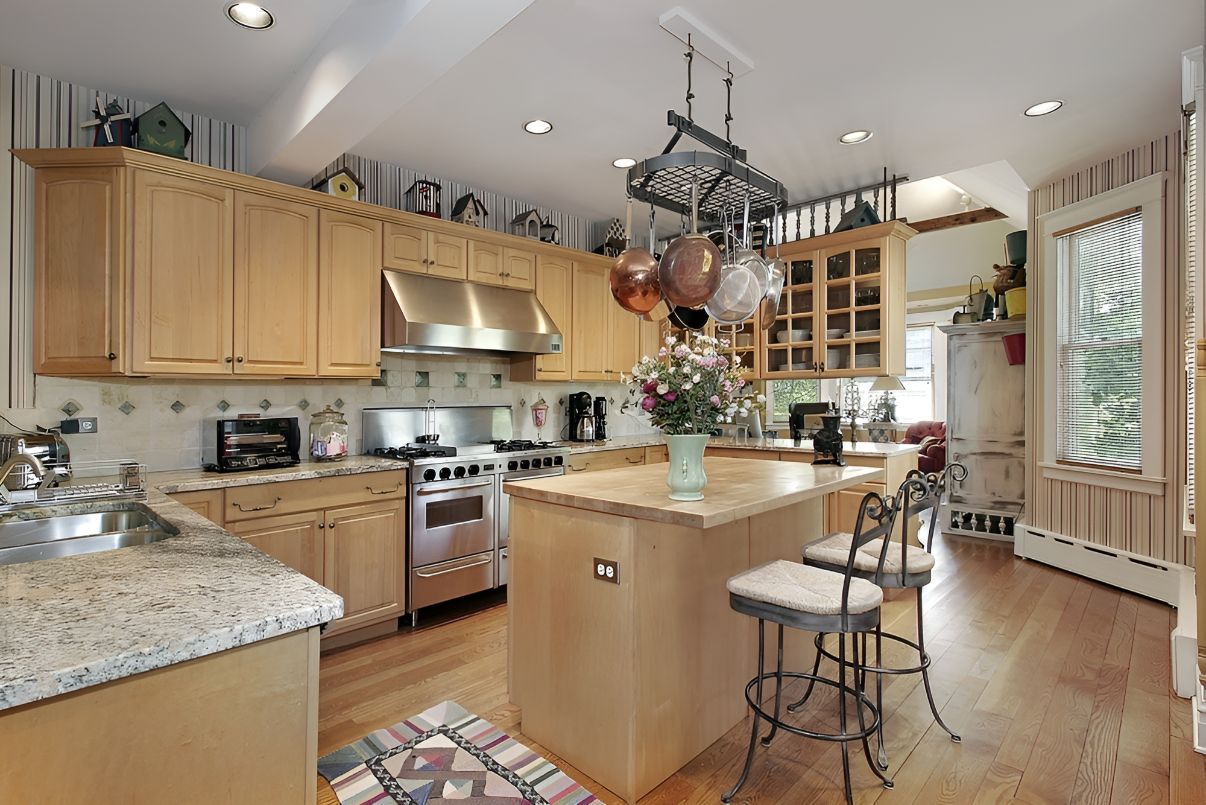 A Kitchen With Wooden Cabinets and Granite Counter Tops — Foreshore Kitchens In Yandina, QLD