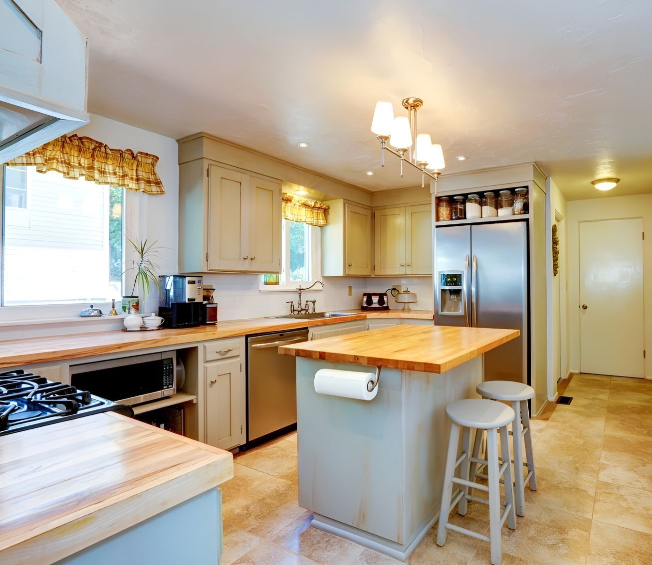 A Kitchen With Stainless Steel Appliances and Wooden Counter Tops — Foreshore Kitchens In Nambour, QLD