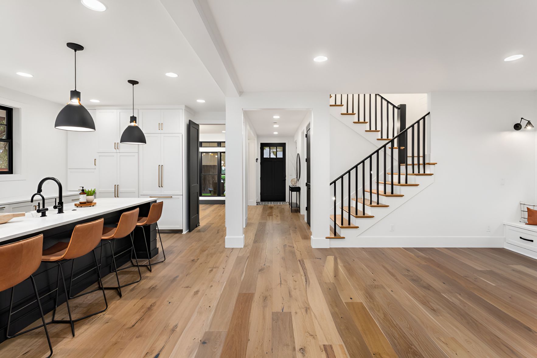 A Kitchen With Hardwood Floors and a Staircase Leading to the Second Floor — Foreshore Kitchens In Caloundra, QLD