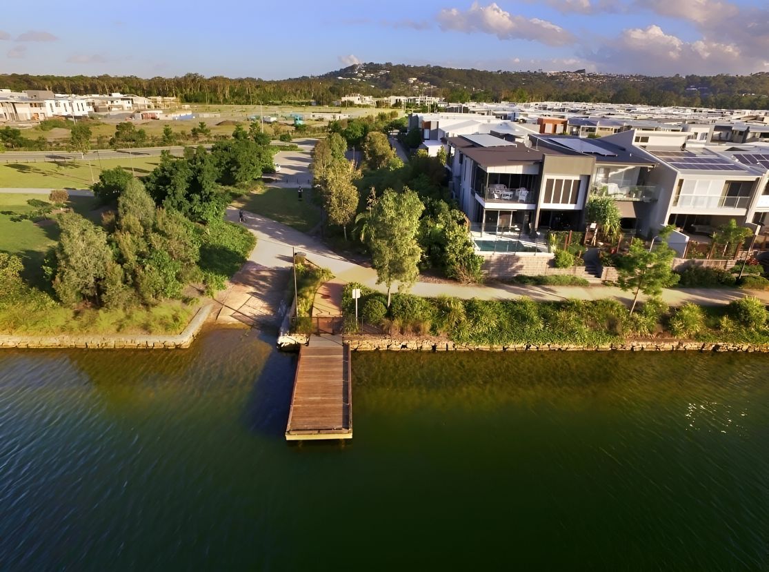 An Aerial View of a Large Body of Water With a Dock in the Middle of It — Foreshore Kitchens In Maroochydore, QLD