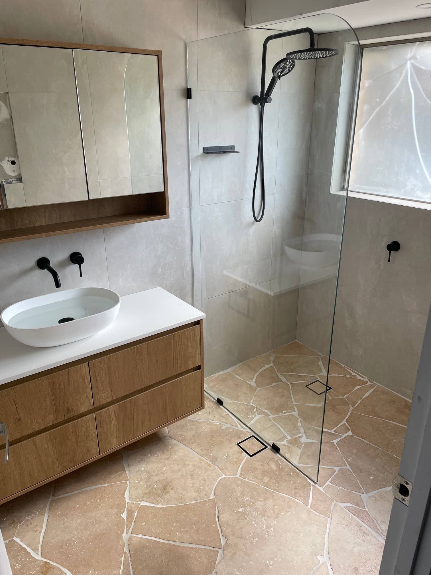 Renovated bathroom featuring stone tiles - Bathroom Renovations Gold Coast