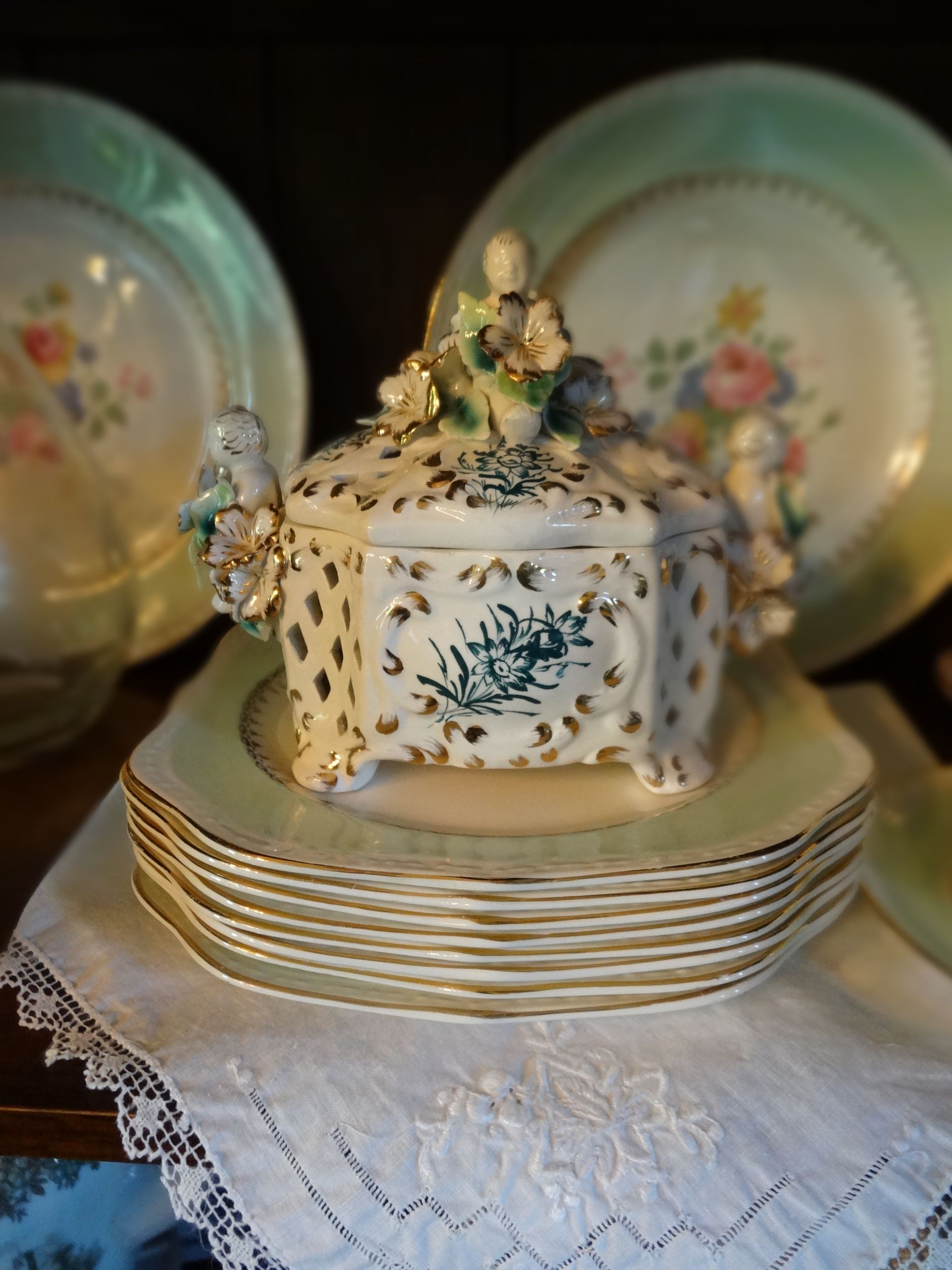 This is a Rococo-style porcelain casket or candy dish, often attributed to Capodimonte or similar Italian or French manufacturers.  1930