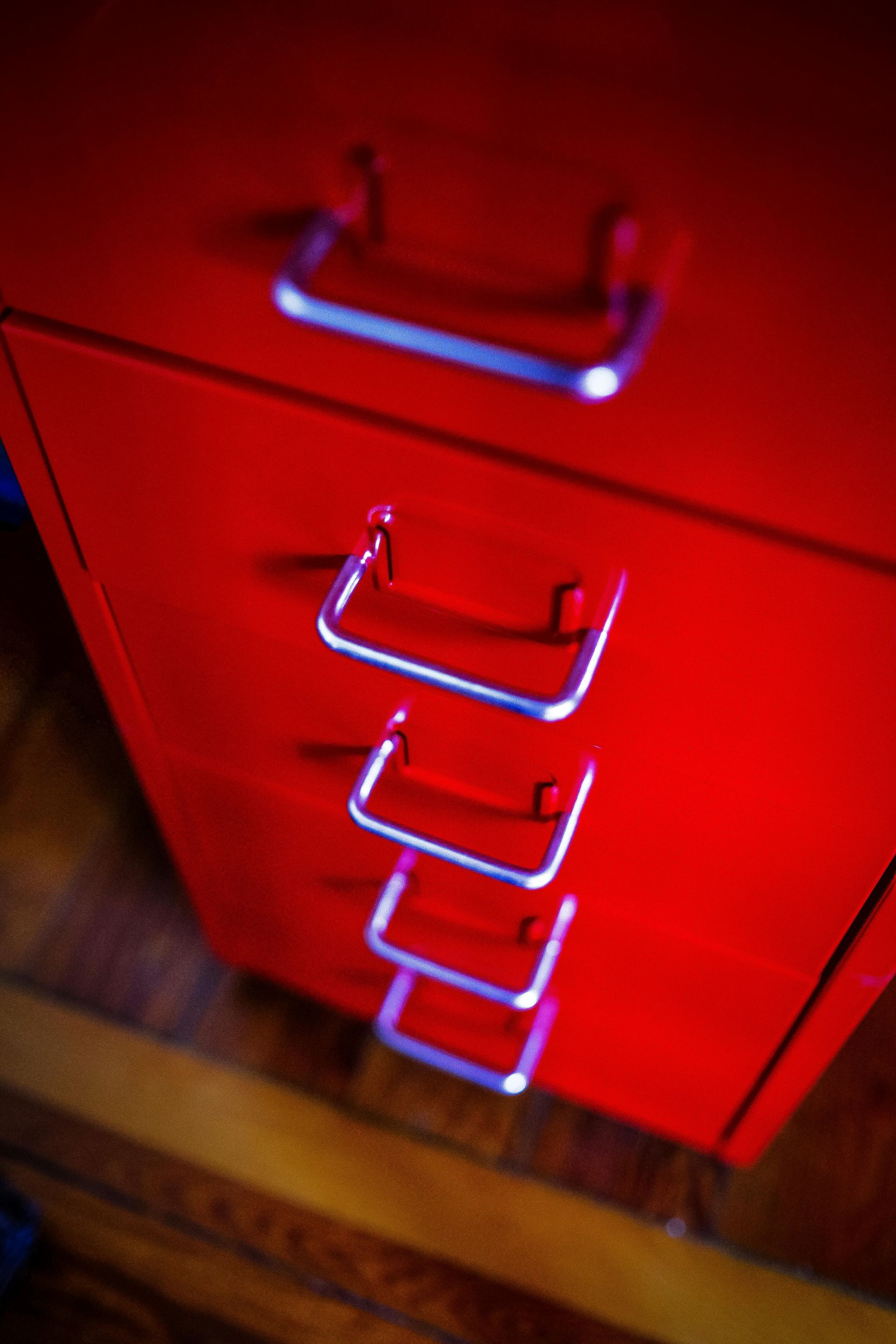 Red metal file cabinet with chrome handles.