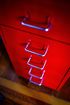 Red metal file cabinet with chrome handles.