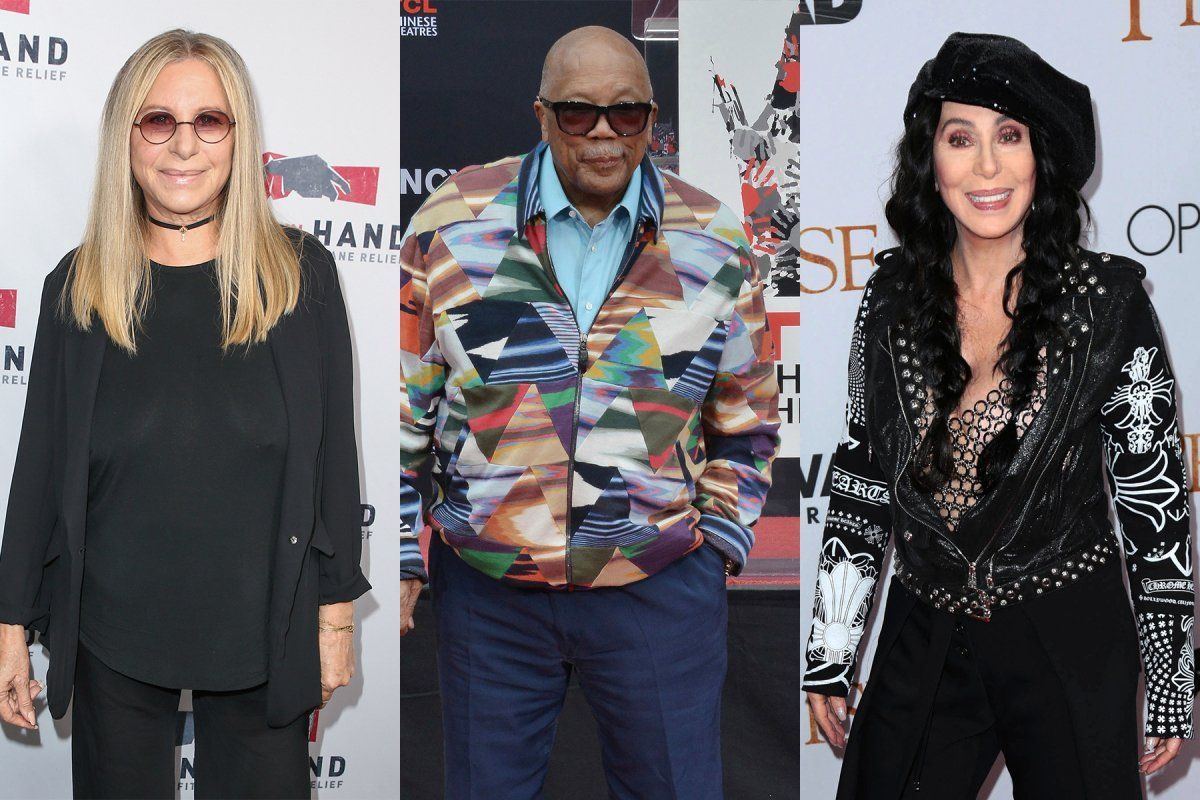 Barbra Streisand, Quincy Jones, and Cher posing on a red carpet with branded backdrops.