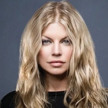 Headshot of singer Fergie against a plain grey background, wearing a black top with her blonde hair loose.