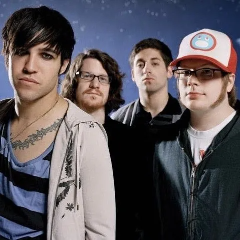 A portrait of the rock band Fall Out Boy against a blue, starry background.
