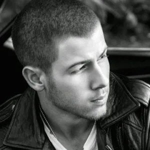 A black-and-white portrait of a man wearing a leather jacket, looking off to the side with a serious expression.