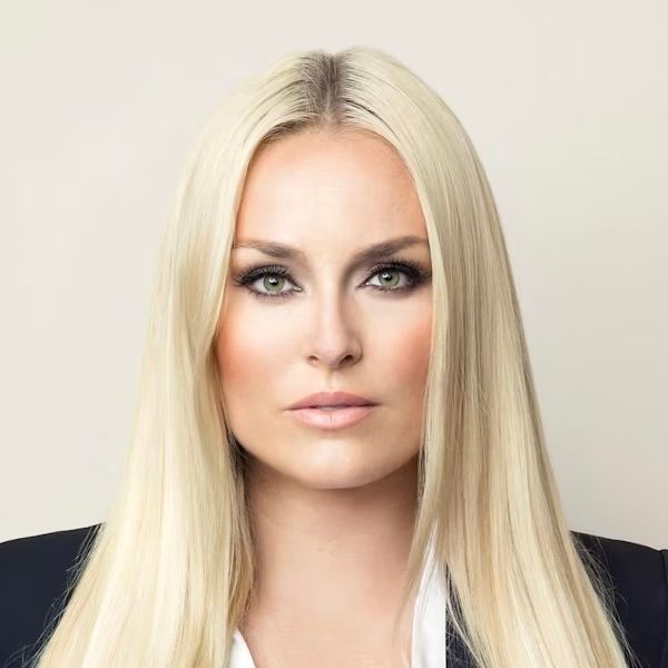 A headshot of a person with long blonde hair, looking directly at the camera with a neutral expression.