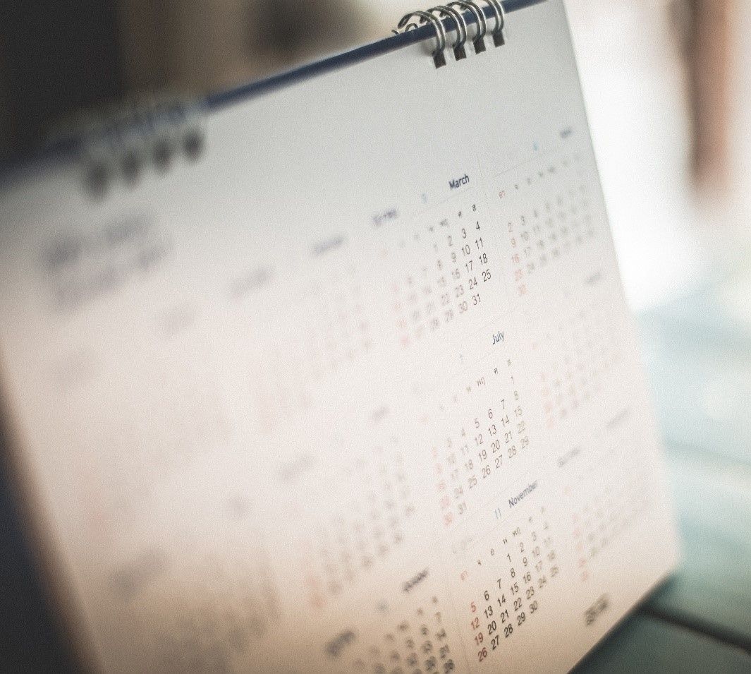 Calendar, white pages, spiral-bound, dates visible.