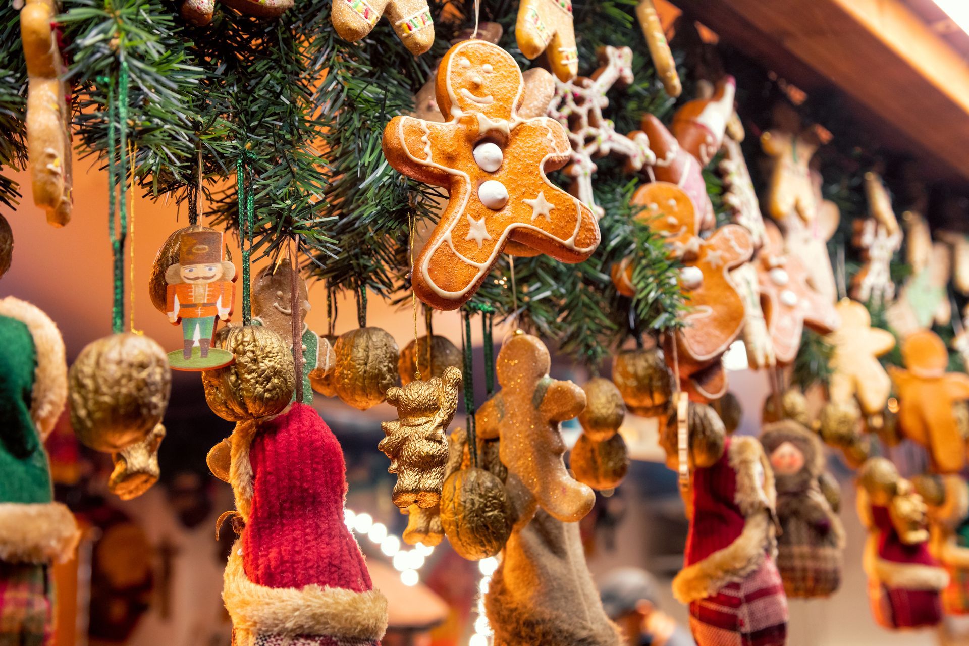 A bunch of Christmas decorations hanging from a stand at a Christmas market