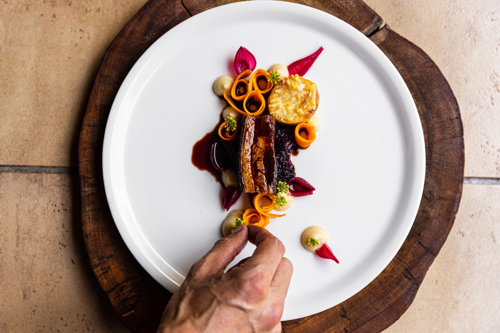 Plate of well presented food on a decorative wooden board