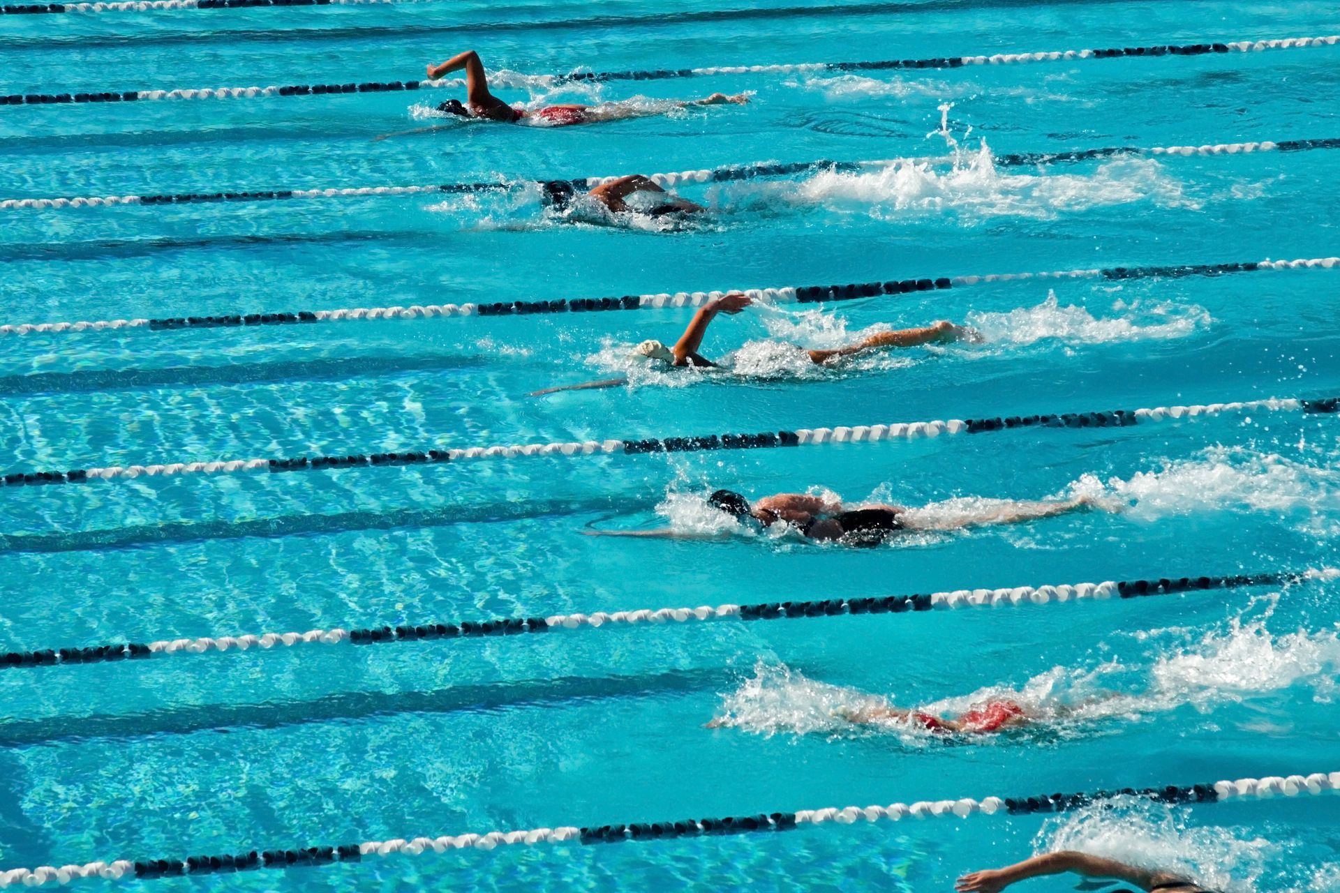 Men and women swimming lengths at a pool in Reading