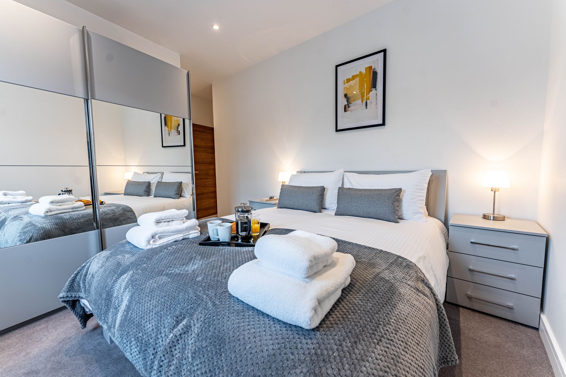 Bedroom with breakfast tray laid on top in an apartment in Wellington House